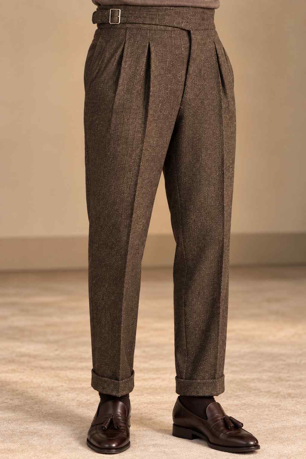 Men’s brown herringbone tweed Gurkha trousers with high waist, pleats, adjustable waistband and cuffed hems