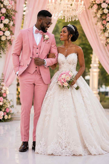 Groom wearing a pink 3 piece wedding suit with matching waistcoat and bow tie beside bride