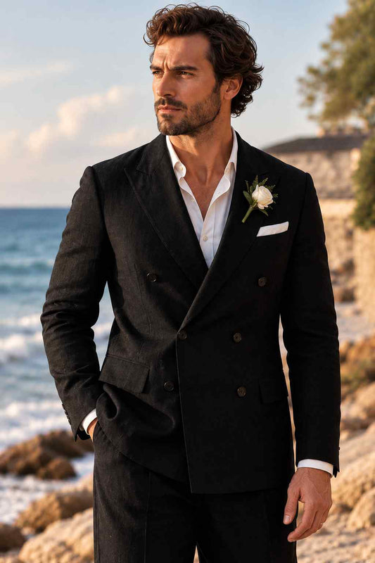 Man wearing a black double-breasted 2-piece suit with wide lapels, white shirt, white pocket square, and rose boutonniere.