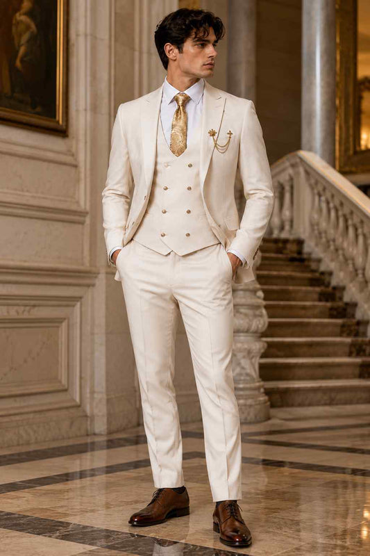 Men’s beige 3-piece groom wedding suit with peak lapel jacket, double-breasted waistcoat, tailored trousers, patterned tie and lapel chain.