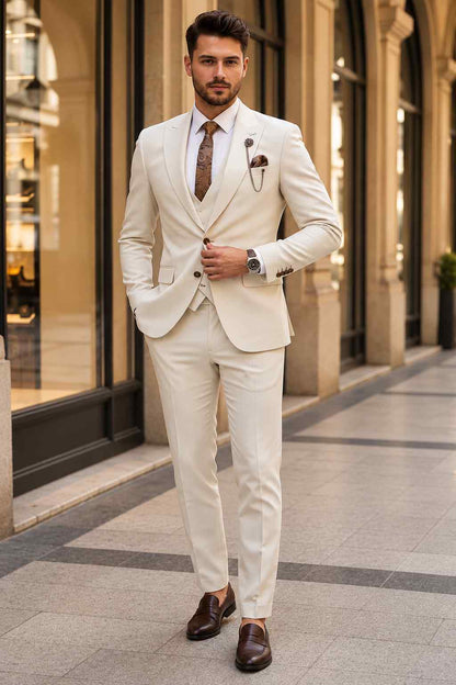 Men’s beige 3-piece suit with peak lapel jacket, matching waistcoat, tailored trousers, white shirt and patterned brown tie.