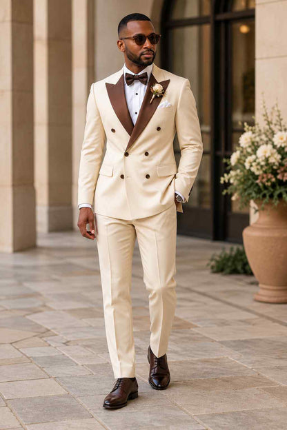 Men's cream 2-piece double-breasted suit with contrasting brown peak lapels, matching trousers and elegant wedding styling.