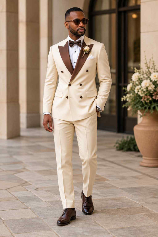 Men's cream 2-piece double-breasted suit with contrasting brown peak lapels, matching trousers and elegant wedding styling.