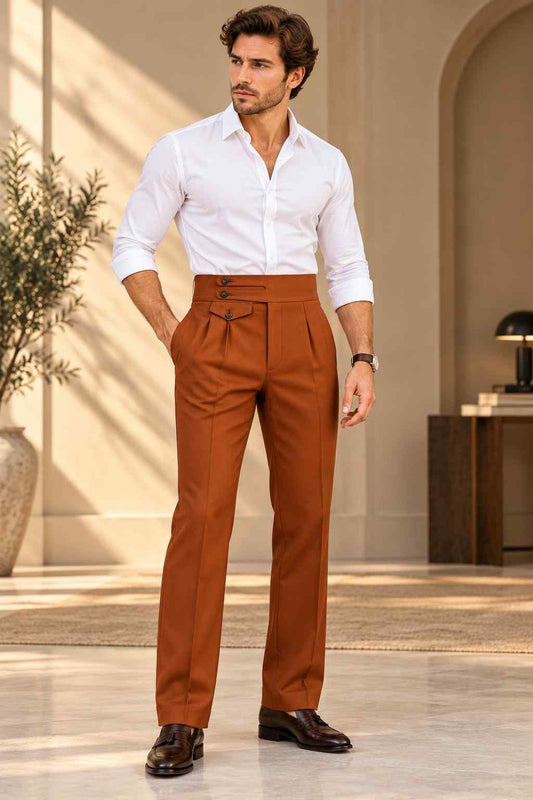 Men’s rust terracotta Gurkha trousers featuring a high waist, double-button waistband, adjustable side fastening, front pleats, and straight legs.