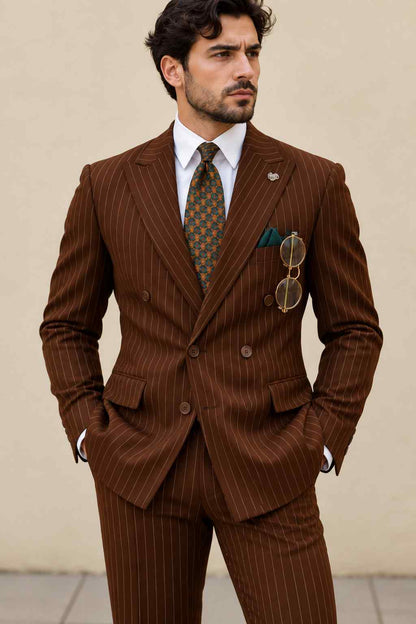 Full-length view of a man wearing a brown pinstripe double-breasted suit with matching trousers, a patterned tie, teal pocket square, and brown dress shoes.