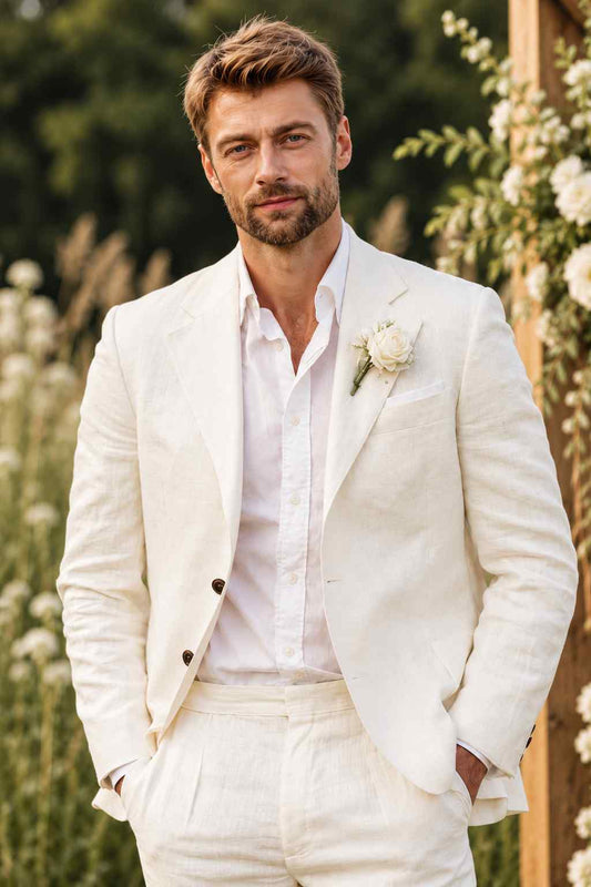 Man wearing a white linen 2-piece suit with a notch lapel blazer, white shirt, and white rose boutonniere.